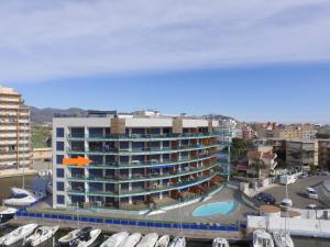a large building with a marina with boats in it at RNET - Apartments Roses Port Trebol in Roses