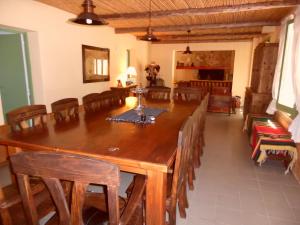 a dining room with a large wooden table and chairs at Casas de Campo Los Corralitos in Mendoza