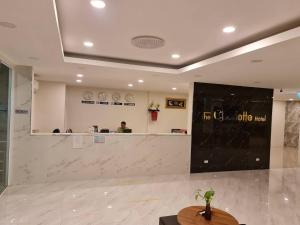 a lobby with a blackboard in the middle of a room at The charlotte smart hotel lopburi in Lop Buri