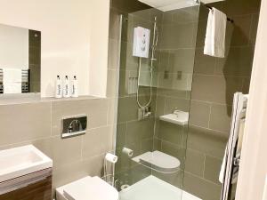 a bathroom with a shower with a toilet and a sink at Kings Chambers Apartments Coventry City Centre in Coventry