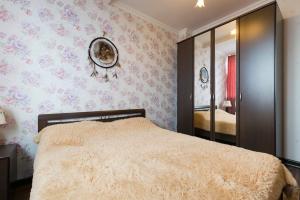 a bedroom with a bed and a mirror at Nadezhda Apartments in Keremet on Timiryazev street 1 in Almaty