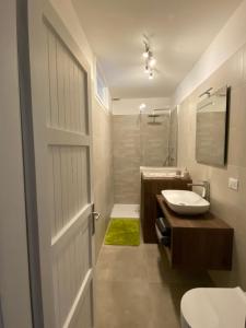 a bathroom with a toilet and a sink and a door at Residence Bellavista in Fondo +28 photos