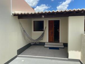 a house with a hammock outside of it at Casa Bem Estar Palestina in Piranhas