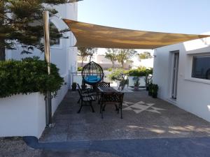 a patio with a table and chairs under a canopy at Niovi in Fira