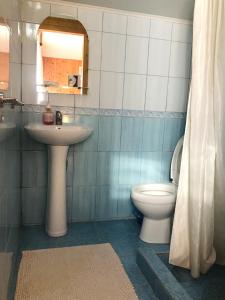 a bathroom with a sink and a toilet and a mirror at За горбами in Yaremche