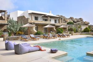 a villa with a swimming pool and a house at AC Village Christoulis in Mýkonos City
