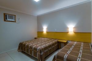 Un pat sau paturi într-o cameră la A Furninha Suites