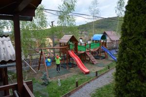 a person standing in front of a playground at Pensiunea Moldovan in Praid