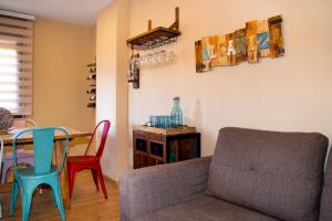 a living room with a couch and a table at MEQUEDO CASA PILARCHO in Alcañiz