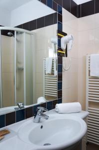 a bathroom with a sink and a mirror at Hotel Ristorante Morus in Burago di Molgora