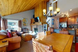 a living room with a table and a fireplace at Remodeled 2 Bedroom East Vail Condo 6G with Hot Tub Market Free Shuttle in Vail