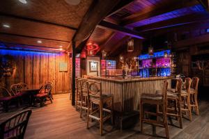 a bar in a restaurant with wooden walls and chairs at Golden Host Resort Sarasota in Sarasota