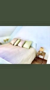 a bedroom with a bed with three pillows on it at Foodiejive in Antwerp