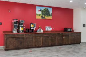 a counter in a room with a red wall at Americas Best Value Inn & Suites Katy in Katy
