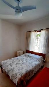 a bedroom with a bed and a ceiling fan at Canto da Cigarra I - Praia do Moçambique - FLORIANOPOLIS - SC in Florianópolis +15 photos