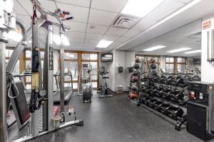 a gym with several treadmills and bikes in it at Zephyr Mountain Ski-In Ski-Out Condo in Winter Park