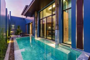 a swimming pool in the backyard of a house at Wings Phuket Villa by Two Villas HOLIDAY in Bang Tao Beach