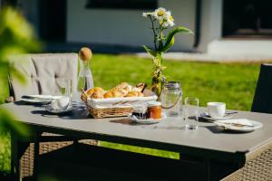 a picnic table with a basket of bread on it at Appartements Bichl ,Haus Ausblick in Wenns
