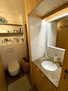 a bathroom with a sink and a toilet and a mirror at Baleal waterfront in Baleal +22 photos
