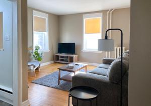 a living room with a couch and a table at The Bayview Motel - Fort France, ON - Lakeside Motel in Fort Frances