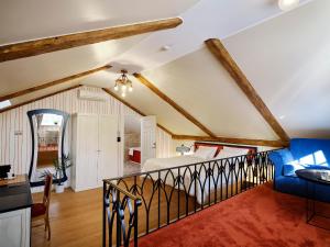 a attic bedroom with a bed and a staircase at Villa Ammende Restaurant and Hotel in Pärnu