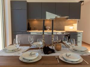 a dining room table with glasses and plates on it at INN Apart Tirol in Innsbruck