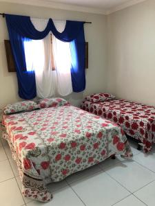 two beds in a room with a window at Pousada Terraço Potiguara in Baía da Traição +49 photos