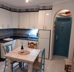 a kitchen with a table with a bottle of wine on it at Casa Salá, alojamiento con encanto en Vera Natura in Vera