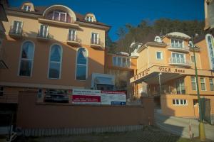 a building with a sign in front of it at Hotel Vila Anna in Trenčianske Teplice