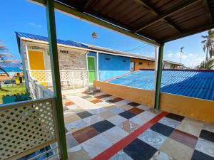 a view from the balcony of a house with a swimming pool at Yellow Moon Guesthouse & Apartments in San Andrés