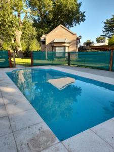a swimming pool with blue water in a backyard at Los Catires in Sierra de la Ventana