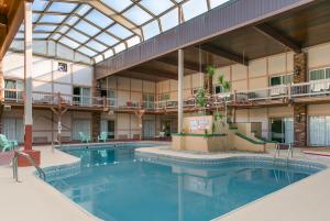 an indoor pool in the courtyard of a hotel at Aspire Hotel and Suites in Gettysburg
