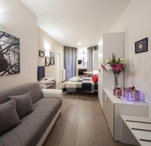 a living room with a couch and a bedroom at Metro Apartment in Collegno +22 photos