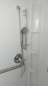 a bathroom door with a shower with a door handle at Valley Hotel in Rosemead