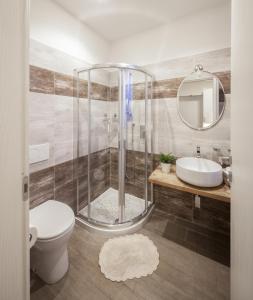 a bathroom with a shower and a toilet and a sink at Metro Apartment in Collegno