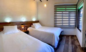 מיטה או מיטות בחדר ב-Cabañas Campestres MaRGuin