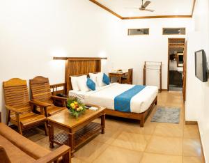 Ένα ή περισσότερα κρεβάτια σε δωμάτιο στο Kalpavanam Heritage Resort