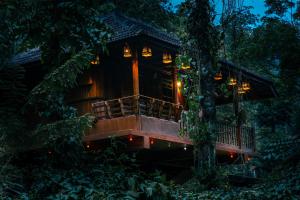 a tree house in the forest at night at Kalpavanam Heritage Resort in Thekkady