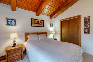 a bedroom with a white bed and a wooden ceiling at N10 Sandtrap Loop in Bartlett +16 photos