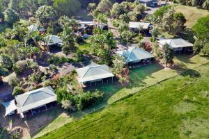 an aerial view of a home with tents on the water at Alstonville Country Cottages in Alstonville