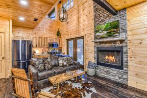 a living room with a couch and a fireplace at Alpine Creekside Chalet in Gatlinburg