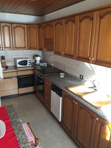 a kitchen with wooden cabinets and a counter top at residenza in zona Pontedilegno T02034 in Villa Dalegno