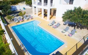 una vista sul tetto di una piscina con sedie e di una casa di Villa Nespereira by Algarve Vacation ad Albufeira