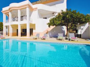 a large swimming pool in front of a house at Villa Nespereira by Algarve Vacation in Albufeira