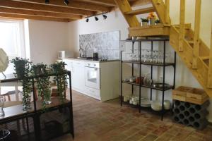 a kitchen with a spiral staircase in a room at Casa do Páteo in Olhão