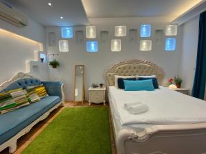 a bedroom with a bed and a couch and mirrors at 恆春洋蔥風格旅居 onion in in Hengchun South Gate +54 photos