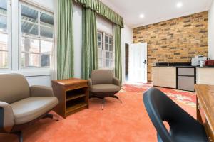a living room with two chairs and a table at The Carrington Inn - Bungendore in Bungendore