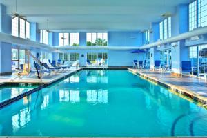 a large pool with blue water in a building at Holiday Inn Express & Suites Petoskey by IHG in Petoskey