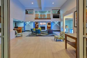 a large living room with blue walls and chairs at Holiday Inn Express Hotel & Suites Petoskey, an IHG Hotel in Petoskey