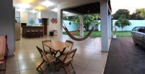 a patio with a table and chairs and a car at Casa - Chácara Bella Arraes in Bauru